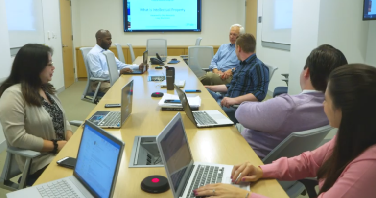 A group of people hold discussion at the Innovation Law Center