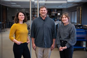 three people standing in front of reading room