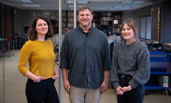 three people standing in front of reading room