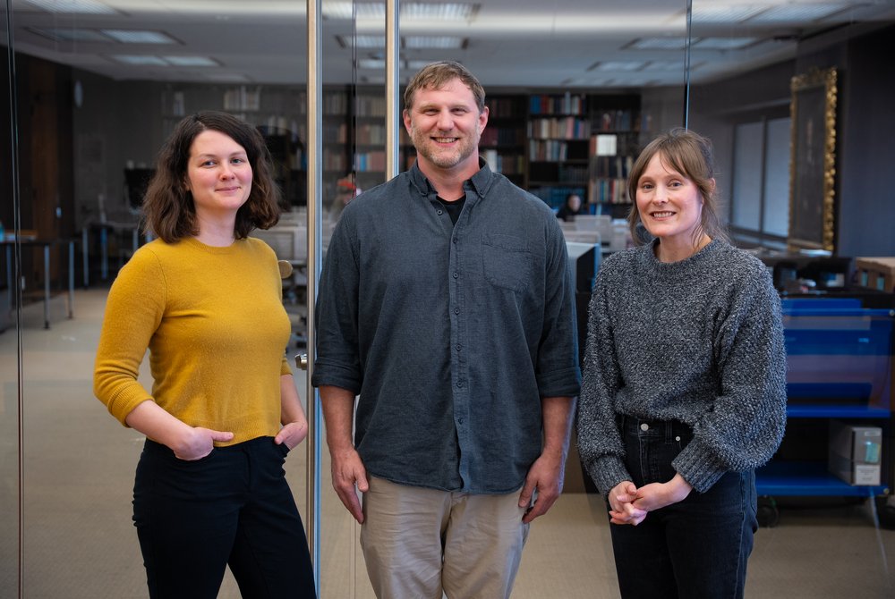 three people standing in front of reading room