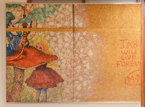 Jabberwocky Mural featuring characters from Alice in Wonderland, including Alice in a red dress meeting a caterpillar sitting on a mushroom and smoking a hookah, with text that reads "Jab will live forever, M+M&#x27; on the right