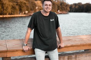 student standing in front of a lake