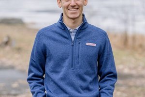 Young man outside in a blue zipped jacket