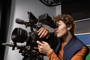 Jeremy Shinder looks into a camera viewfinder