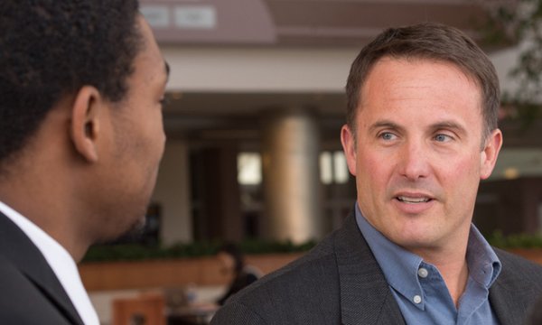 Dr. John Torrens talking to another person