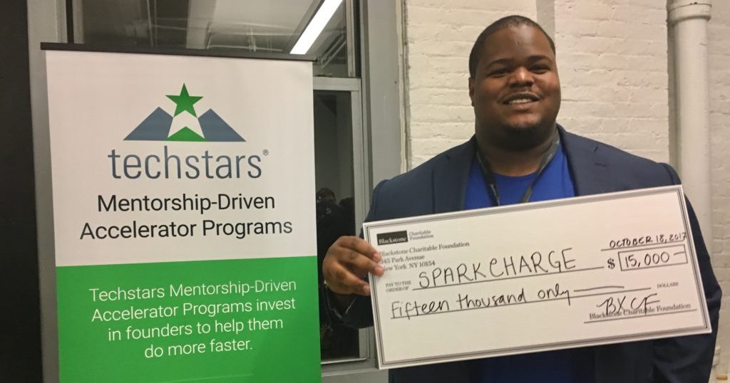 Josh Aviv holding an oversized check
