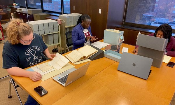 three students working at table