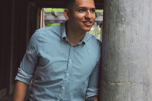 person leaning against concrete wall