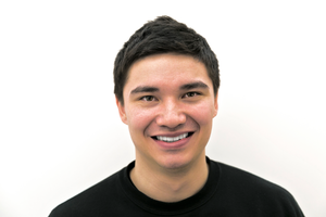 Kai Patricio in black t-shirt smiles for a photo