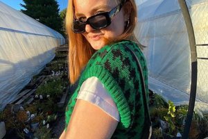 a woman wearing sunglasses at a farm