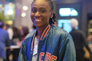 A woman in Syracuse jacket smile for a photo