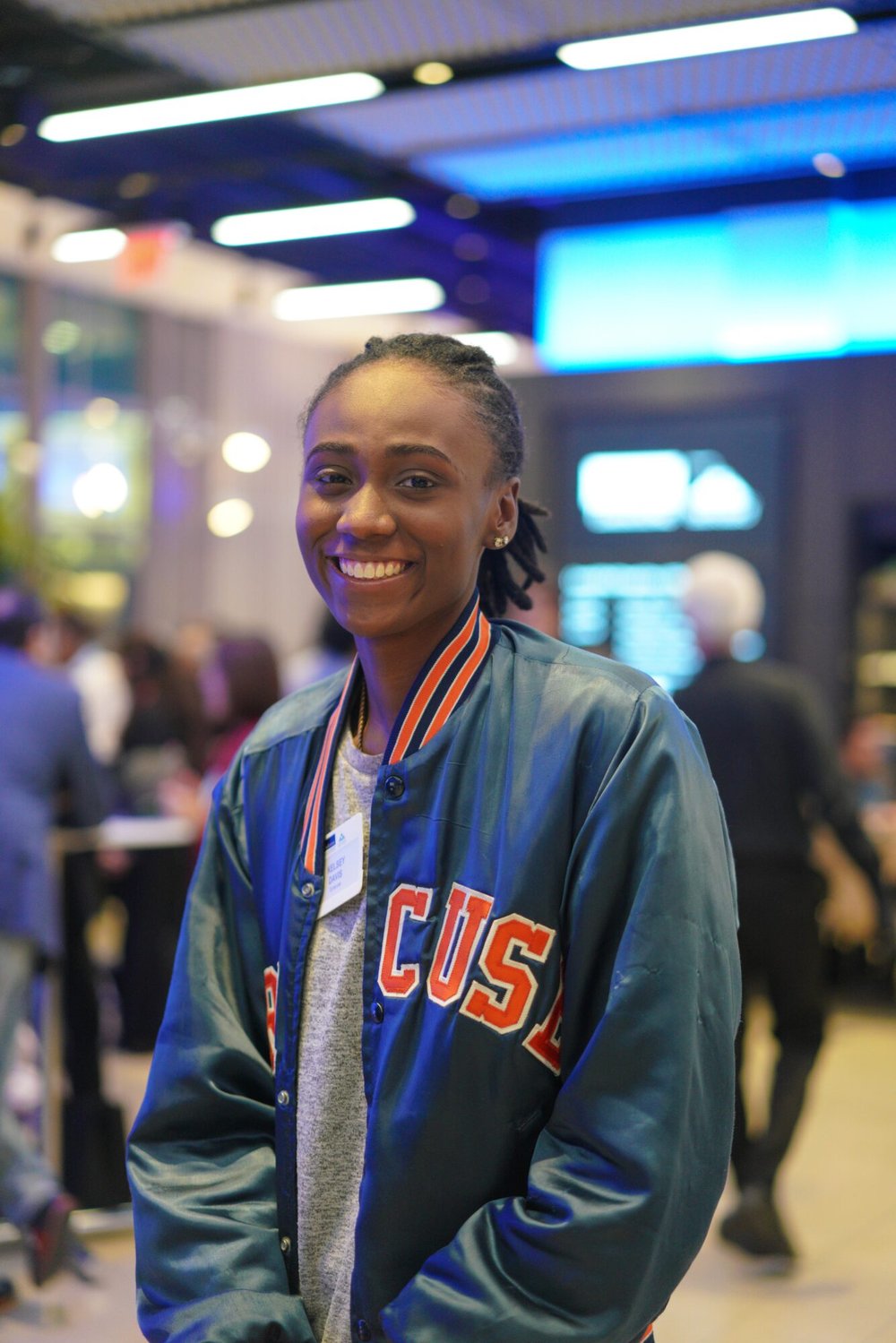A woman in Syracuse jacket smile for a photo