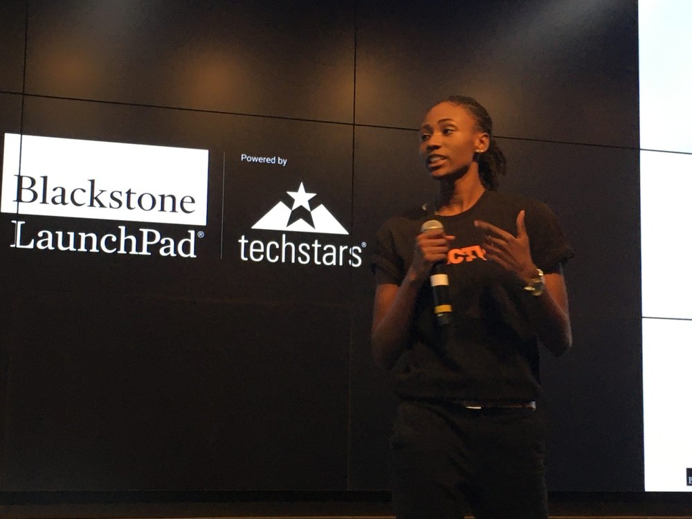 woman pitching to an audience