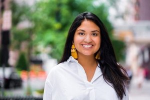 headshot of Kennedy Patlan standing outdoors, smiling at the camera