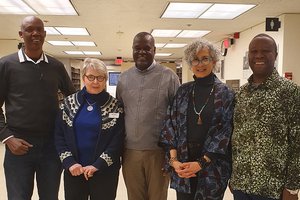 Three Kenya Archivists standing with two female SU Libraries staff
