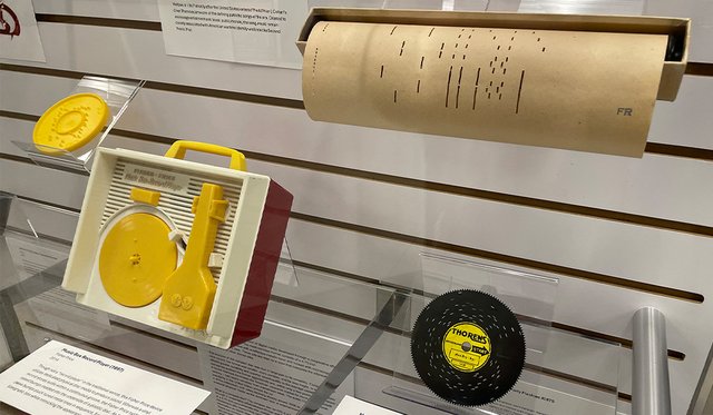 Display featuring audio media objects with paper and plastic discs