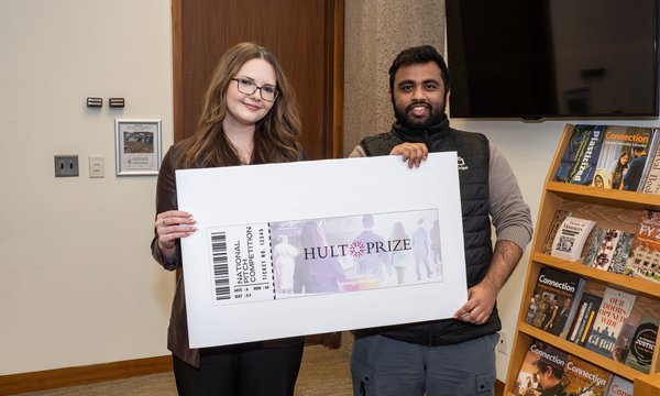 two people holding oversize check