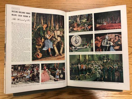 An opened magazine with an “Oz” spread including text and colored images from the film.