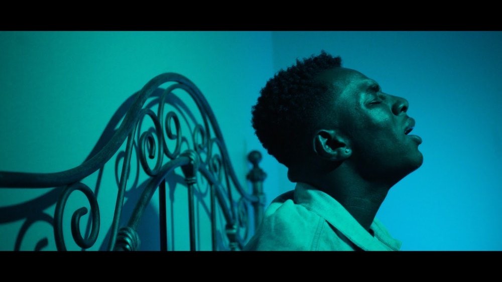 photo of a young man against a blue background
