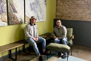 two men sitting in lobby area