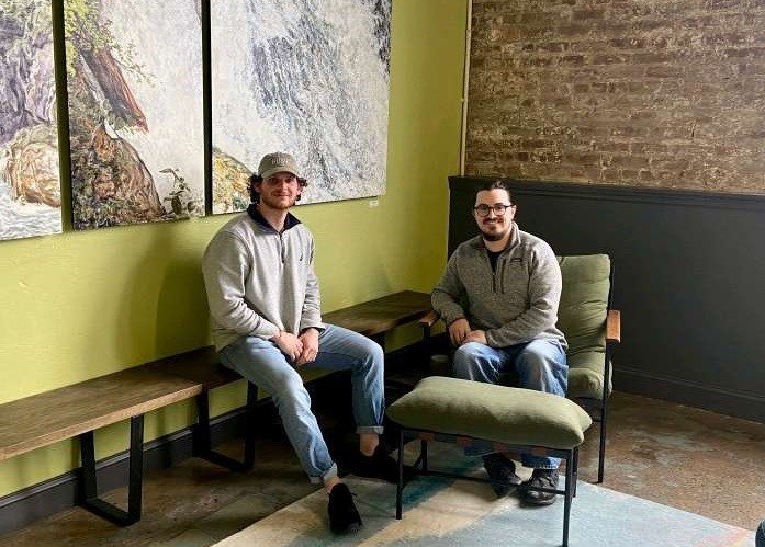 two men sitting in lobby area