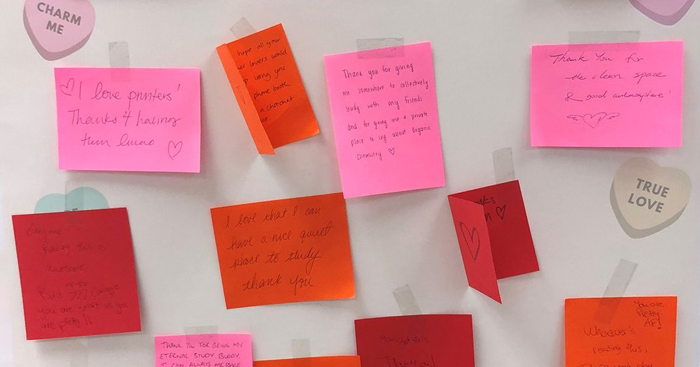 white board with red and pink and orange and purple post-it notes