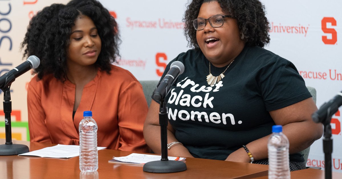 two women speaking to microphone