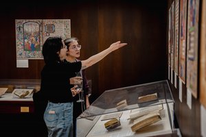 two people looking at exhibition and pointing