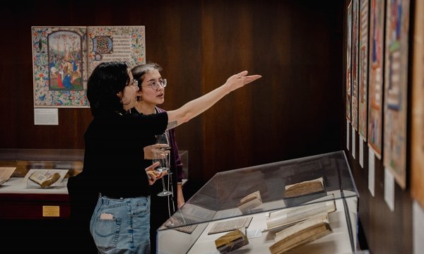 two people looking at exhibition and pointing