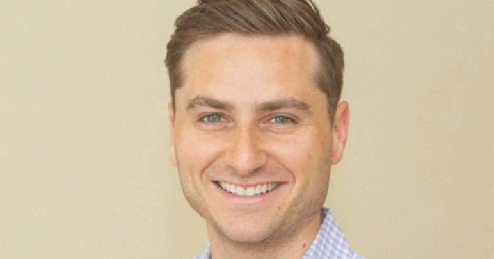 Michael Steinmetz in flannel shirt pose for a headshot