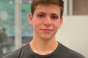 young man in front of a glass wall