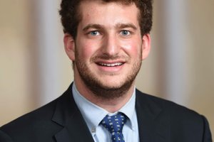 Student in a suit looking at the camera