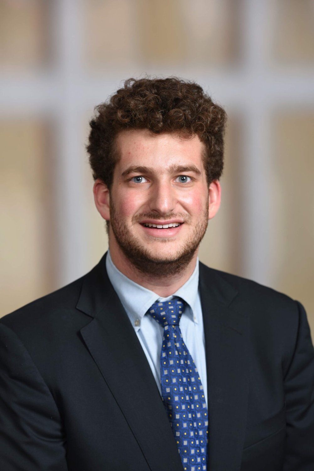 Student in a suit looking at the camera
