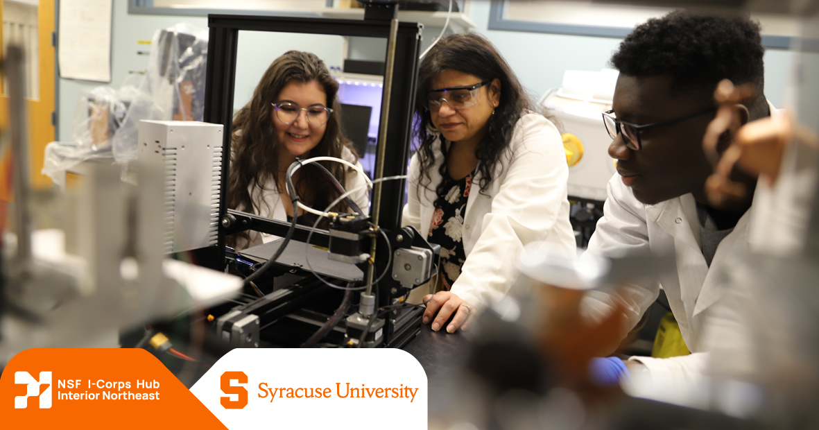 Three researchers observing machinery with NSF I-Corps logo with Syracuse University logo in corner
