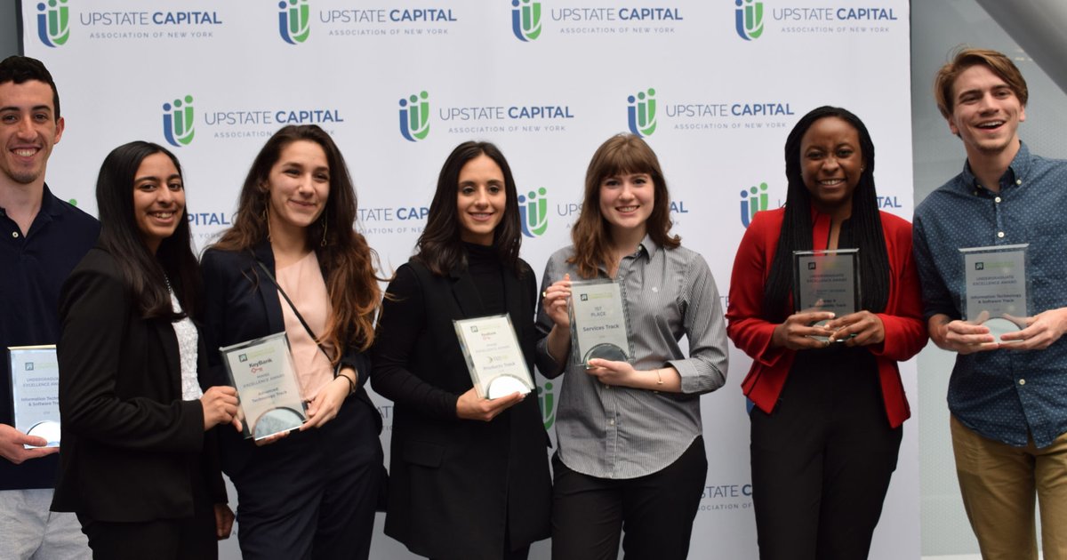 Former SU NYBPC winners each holding an award