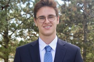 Student entrepreneur in a suit facing the camera