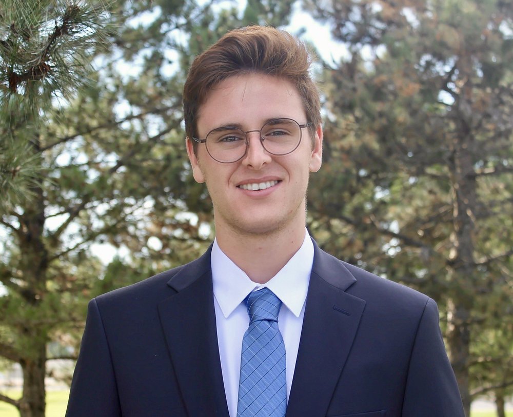 Student entrepreneur in a suit facing the camera