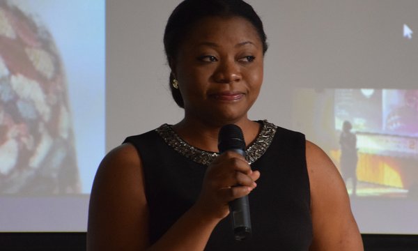 person speaking with microphone in hand