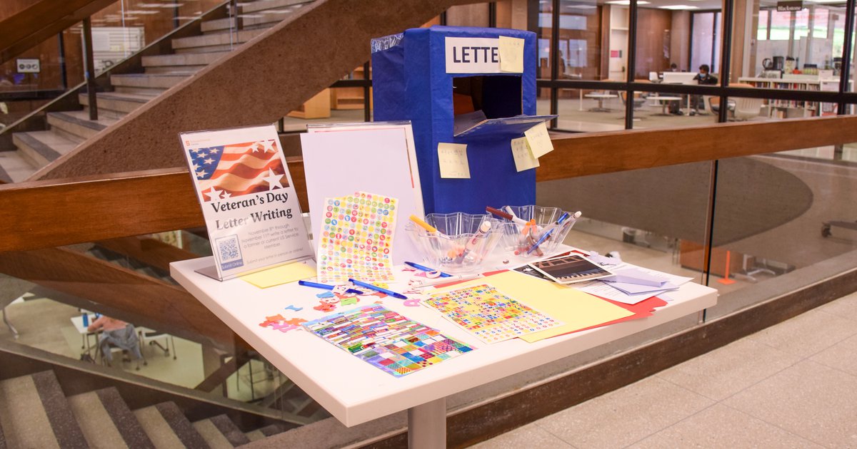 table with letter writing supplies, cardboard mailbox and directions