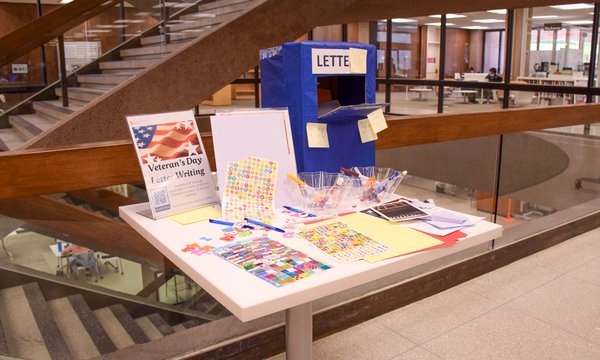 table with letter writing supplies, cardboard mailbox and directions