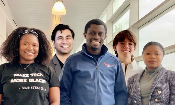 five students standing next to each other