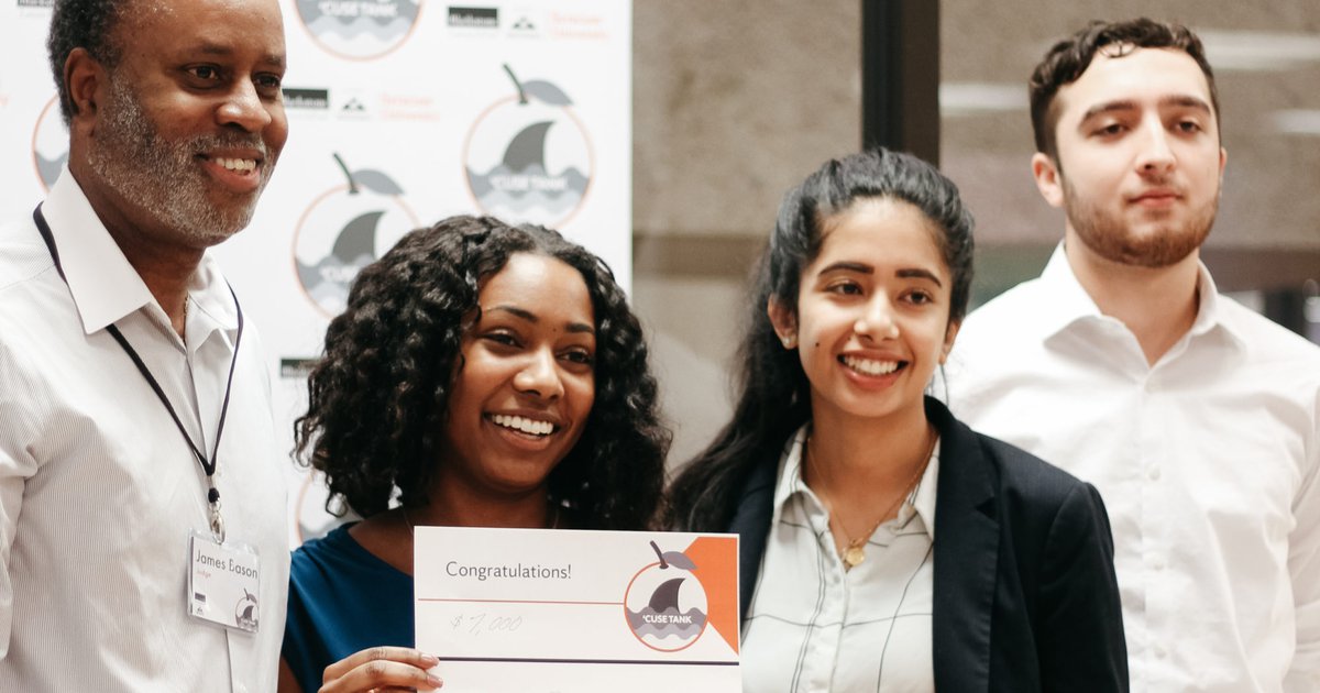 Students posing with winning check at Blackstone LaunchPad business competition