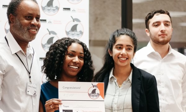 Students posing with winning check at Blackstone LaunchPad business competition