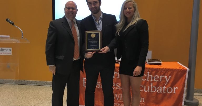 Quentin Rosso ’18 poses for a photo with two people after named Student Entrepreneur of the Year