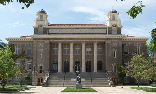 Carnegie Library surrounded by green trees and cloudy blue sky