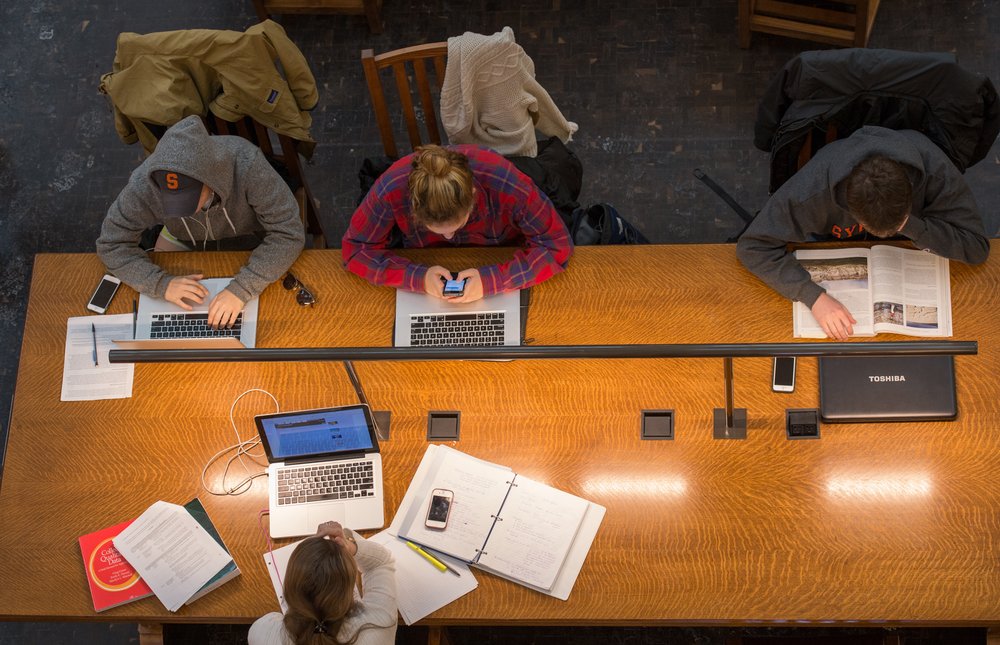 students working on laptops in library