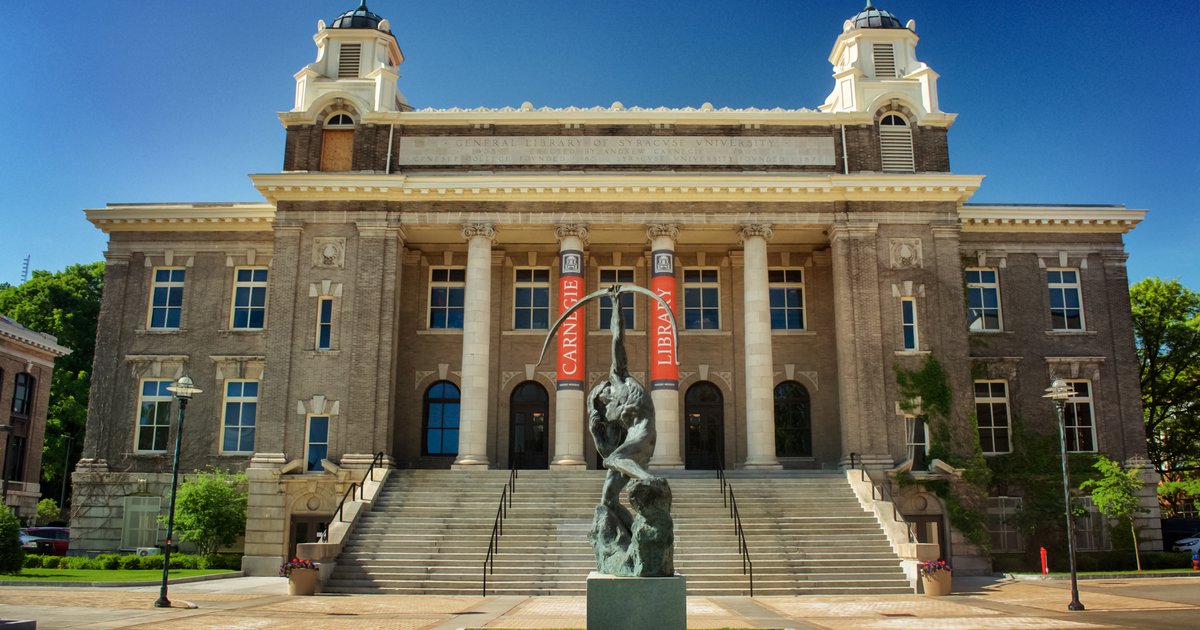 Front view of Carnegie Library and Saltine Warrior statue on a sunny day