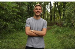 Man in woods smiling