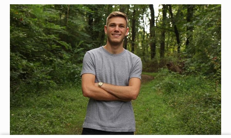 Man in woods smiling