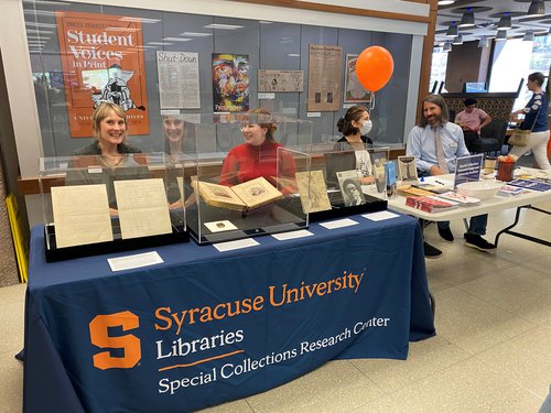 SCRC table with staff sitting behind collections materials in glass cases